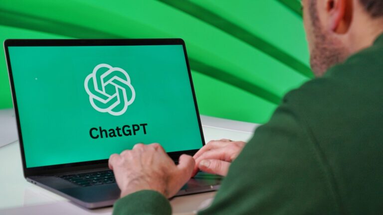 Logo erstellen mit Chat-GPT Person typing on a laptop displaying ChatGPT logo with a green vibrant setting.
